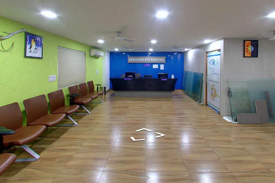 Reception and waiting area with green walls and the blue reception desk